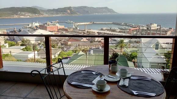 Hotel terrace with view over city, sea and mountains