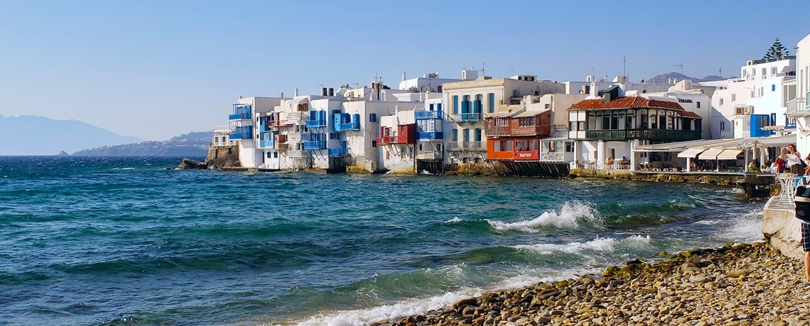 White and blue sea side houses, the sea and pebble beach