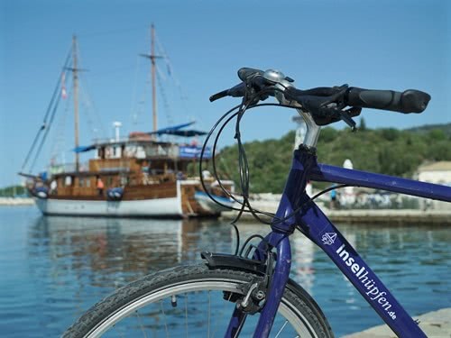 Inselhüpfen-Fahrrad vor dem Motorsegler Panagiota