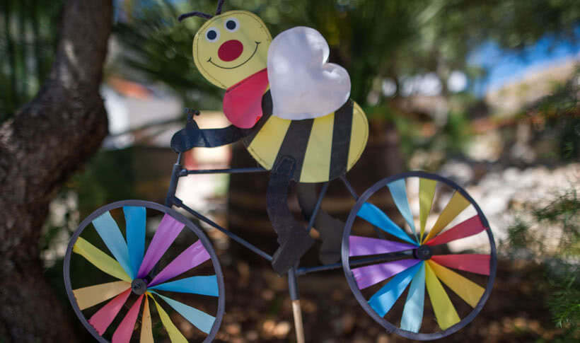 Sculpture: Bee on bicycle with rainbow coloured wheels